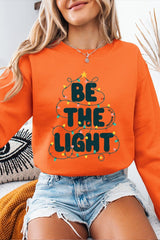 UL180P-E3202 Be the Light Christmas Graphic Plus Sweatshirt $25