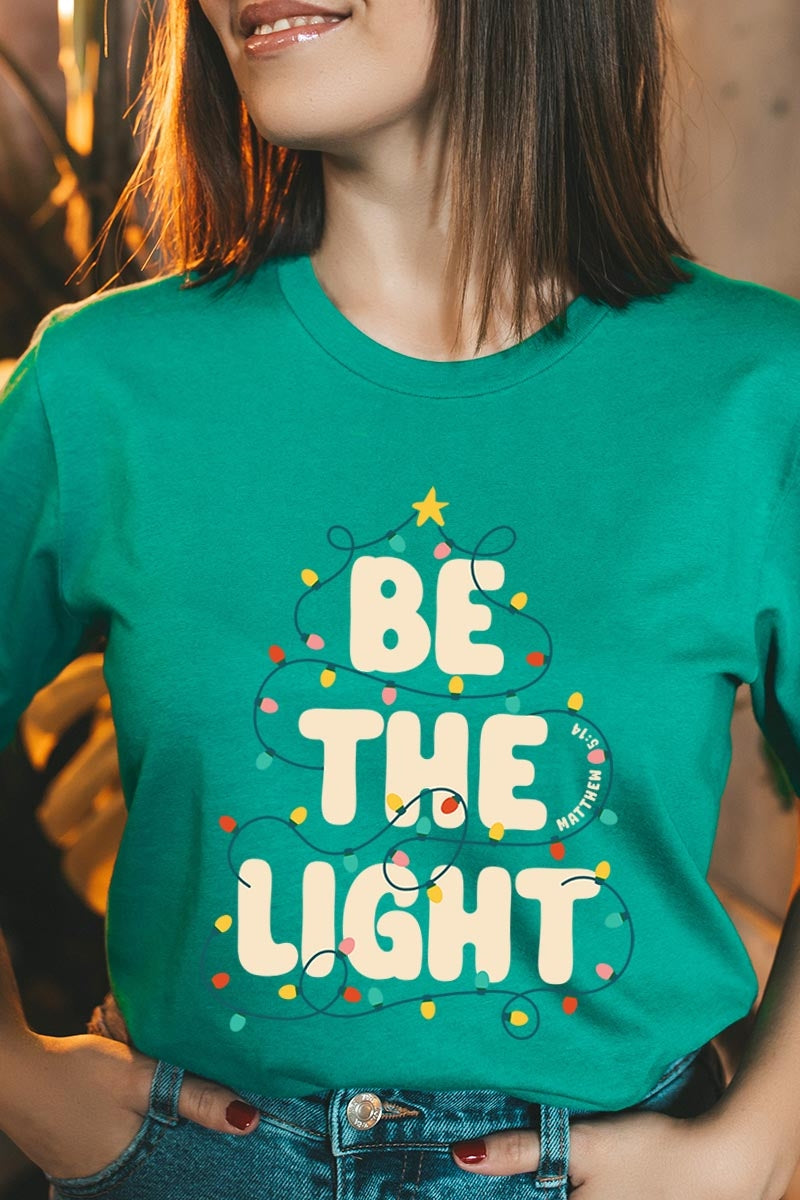 US3001-E3202 Be the Light Christmas Graphic Tee $12.5