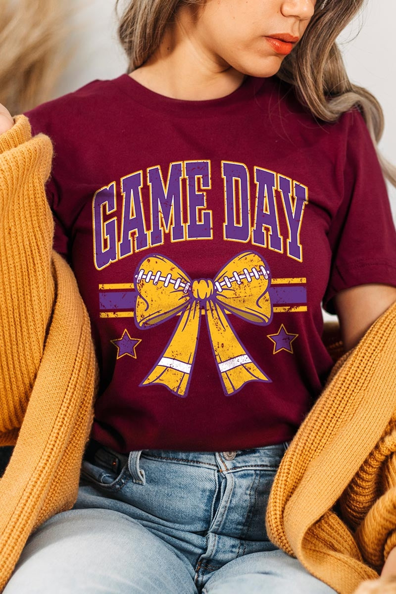 US3001P-E3063 Purple Game Day Football Bow Graphic Plus Tee $16