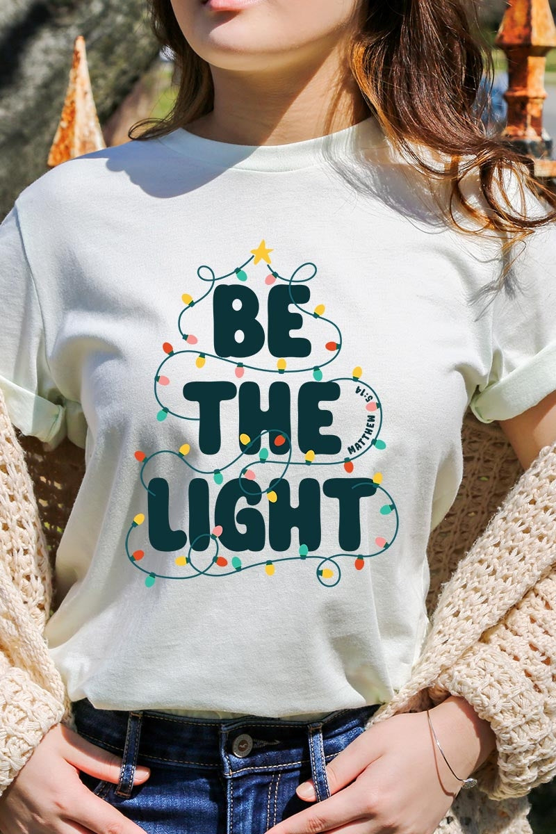 US3001P-E3202 Be the Light Christmas Graphic Plus Tee $16